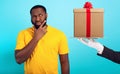 Confused man is suspicious about a gift. concept of options, confusion, indecision Royalty Free Stock Photo