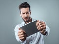 Confused man watching his tablet Royalty Free Stock Photo