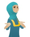 Confused muslim business woman shrugging shoulders