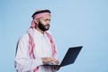 Confused muslim man working on laptop Royalty Free Stock Photo