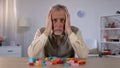 Confused pensioner trying remember to combine blocks, brain disease, alzheimer Royalty Free Stock Photo