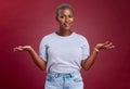 Confused, question and why black woman on studio red background, body language and facial gesture for risk decision Royalty Free Stock Photo
