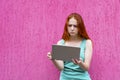 Confused redhead girl using tablet pc Royalty Free Stock Photo
