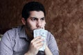 Confused sad arab young businessman with dollar bill Royalty Free Stock Photo