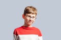 Confused schoolboy in glasses scratching his head Royalty Free Stock Photo