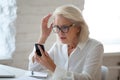 Frustrated woman hold cellphone having device troubles Royalty Free Stock Photo