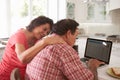 Confused Senior Hispanic Couple Sitting At Home Using Laptop Royalty Free Stock Photo