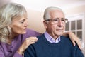 Confused Senior Man Suffering With Depression And Dementia Being Comforted By Wife Royalty Free Stock Photo