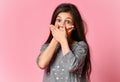 Confused shocked young woman over pink background Royalty Free Stock Photo