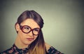 Confused skeptical woman in glasses thinking looking perplexed