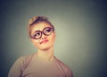 Confused skeptical woman in glasses thinking planning looking up Royalty Free Stock Photo