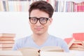 Confused student surrounded by books Royalty Free Stock Photo