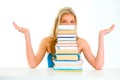 Confused teengirl looking out of pile of book Royalty Free Stock Photo