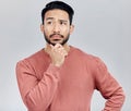 Confused, thinking and Asian man with ideas, decision and thoughtful against grey studio background. Japan, male and guy Royalty Free Stock Photo