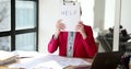 Confused tired woman sitting in office holds inscription help