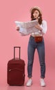 Confused Tourist Girl Holding Map Standing With Suitcase In Studio