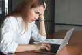 Confused upset young Asian business woman suffering from severe from depression in workplace. Royalty Free Stock Photo