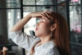 Confused upset young Asian business woman suffering from severe from depression in workplace Royalty Free Stock Photo