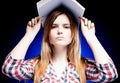 Confused and upset young girl holding exercise book on her head Royalty Free Stock Photo