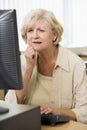 Confused woman frowning at computer