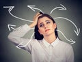 Confused woman with many twisted arrows coming out of her head Royalty Free Stock Photo