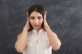 Confused woman puts her hands on ears Royalty Free Stock Photo
