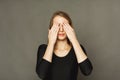 Confused woman puts her hands on eyes Royalty Free Stock Photo