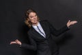 Confused woman thinking uncertainly about the answers to the question. Portrait in studio in front of a black background Royalty Free Stock Photo