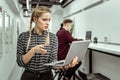 Confused woman with two braids looking nonplussed while dealing with work aspects