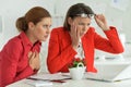 Confused women architects working in modern office Royalty Free Stock Photo