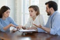 Confused young couple dissatisfied with contract terms of conditions.