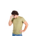 Confused young man, long curly hair style, keeps hand to forehead, thoughtful gesture, looking down suspicious isolated on white