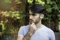 Confused young man scratching his head, looking up Royalty Free Stock Photo