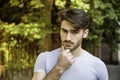 Confused young man scratching his head, looking up Royalty Free Stock Photo