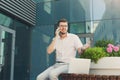 Puzzled businessman making a phone call outdoors Royalty Free Stock Photo