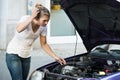 Confused Woman Looking At Broken Down Car Engine Royalty Free Stock Photo