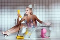 confused young woman in wash tub holding retro telephone Royalty Free Stock Photo