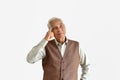 Confusing and forgetful elderly asian man with thinking gesture, Alzheimer`s disease. Royalty Free Stock Photo