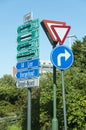 Confusing road direction signs in dutch informing drivers on street crossing Royalty Free Stock Photo