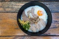Congee with soft boiled egg and pork liver, pork intestines, ginger sliced, spring onion sliced, coriander sliced Royalty Free Stock Photo