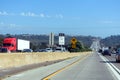 A congested section of I-5 with visible HOV lane signs and a warning about slippery roads when wet Royalty Free Stock Photo