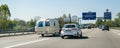 Congested traffic on French highway with vintage RV trailer