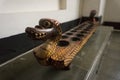 Congklak as one of traditional game made from wood with dragon head carving and lentils displayed on Batik Museum photo