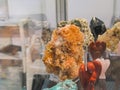 A Conglomerate of Citrine Quartz Crystals Among a Collection of Minerals