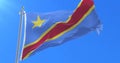 Flag of the Democratic Republic of the Congo waving at wind with blue sky, loop