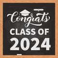 Congrats Class of 2024 inscription on chalkboard with wooden frame. Congratulations to graduates typography poster Royalty Free Stock Photo