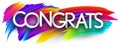 Congrats paper word sign with colorful spectrum paint brush strokes over white. Royalty Free Stock Photo