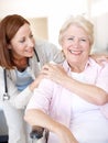 Congratulating her on such a speedy recovery. Portrait of a mature nurse and her elderly patient sharing an affectionate Royalty Free Stock Photo