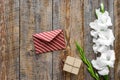 Congratulation. Envelope and box in kraft paper near flower gladiolus on wooden table top view copyspace