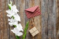 Congratulation. Envelope and box in kraft paper near flower gladiolus on wooden table top view copyspace